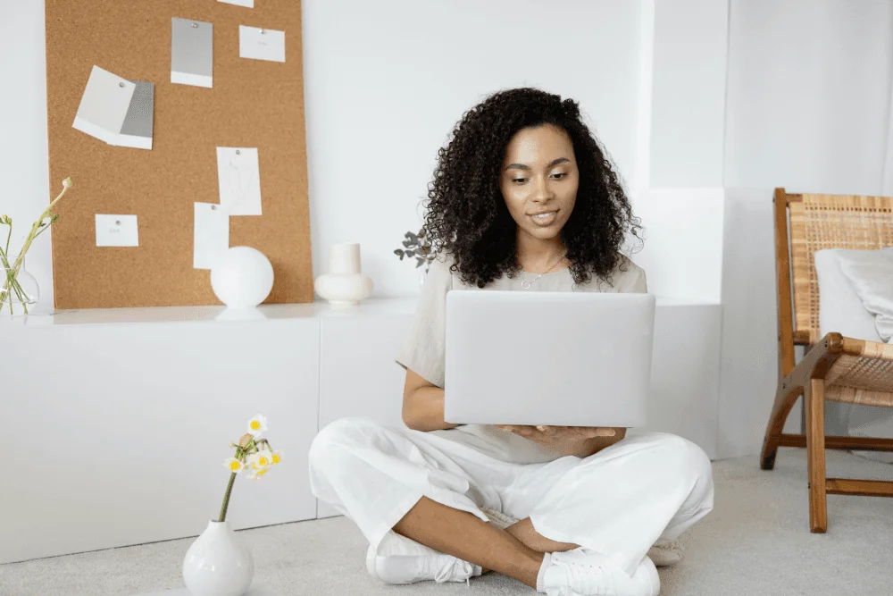 A remote staff member working through self-paced onboarding on a laptop, the kind of distributed-team training ID Atlas designs for nonprofits.